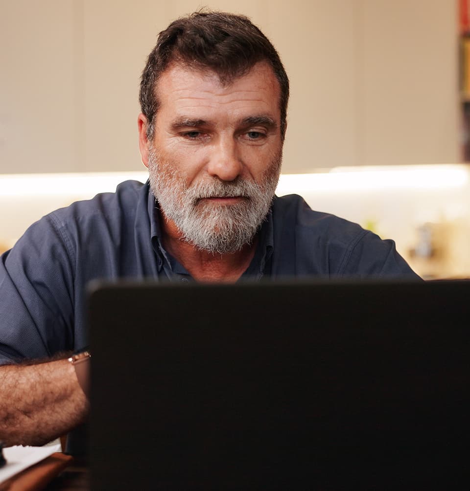 Spanish man looking at a laptop